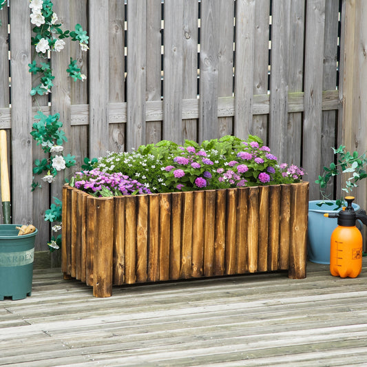 The wooden planter filled with purple and pink flowers on a wooden deck