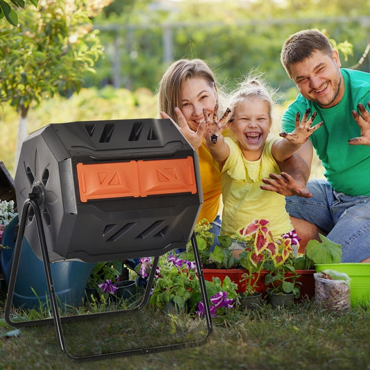 A smiling family in a garden with the rotating dual chamber composter