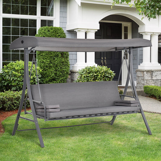 The three seater garden swing chair with canopy is set up on a lawn in front of a house