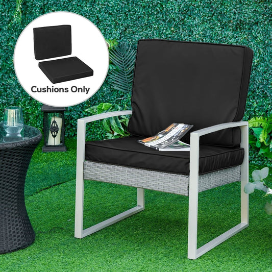Black garden chair cushions on a rattan sofa chair on a patio