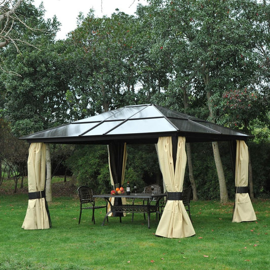 The garden pavilion set up with a table and chairs underneath on a lawn