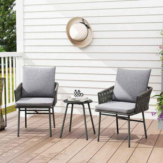 The rattan furniture set arranged on a wooden patio with grey cushions and a small round table