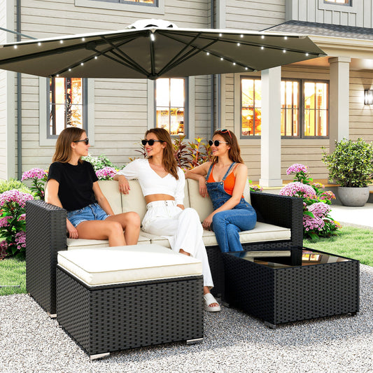 Three friends relaxing on the rattan furniture set in a garden setting under a large umbrella