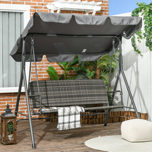 The grey three-seater outdoor swing chair in a garden setting on a wooden deck