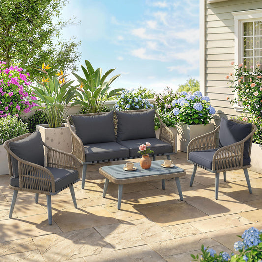 Grey rattan garden furniture set with loveseat, armchairs and coffee table on a patio