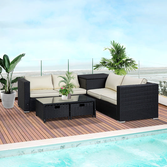 The rattan furniture set arranged on a wooden balcony deck next to a swimming pool