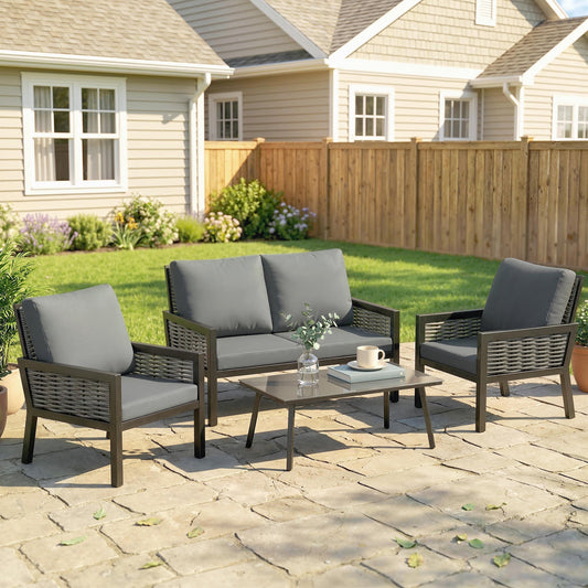 The dark grey rattan garden furniture set arranged on a patio
