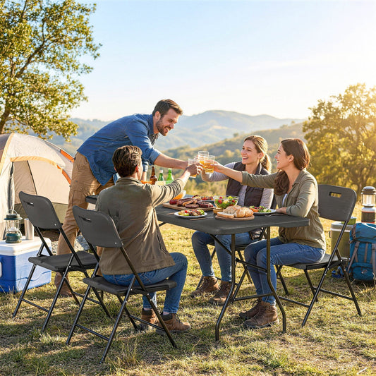 Four people toasting drinks at a picnic table and chairs set outdoors by a tent