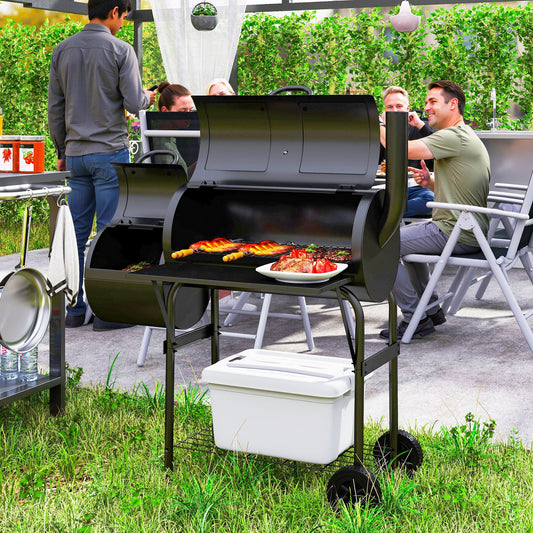 The charcoal grill being used for a barbecue party in a garden setting