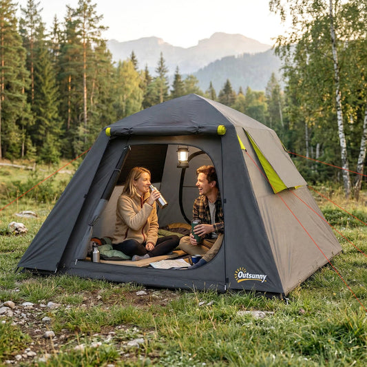 A grey and green camping tent pitched in a forest with two people sitting inside drinking