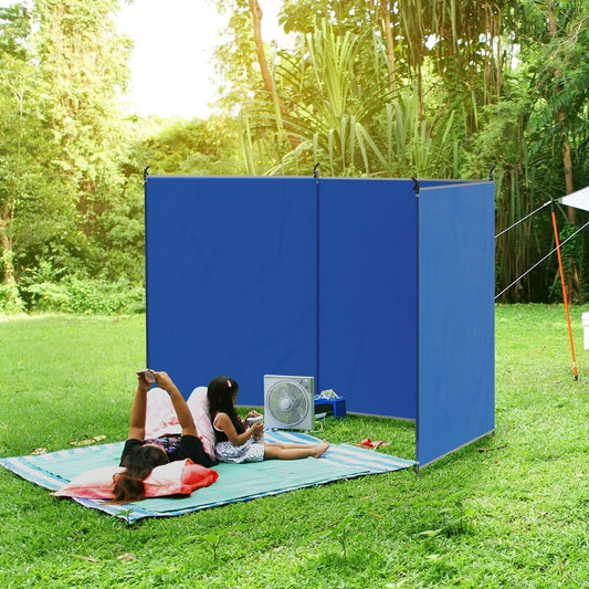 The blue windbreaker providing a private shelter for a family sitting on a picnic blanket