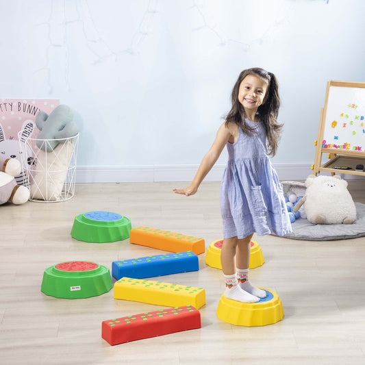 A young girl smiling as she steps on the colourful kids stepping stones in a room
