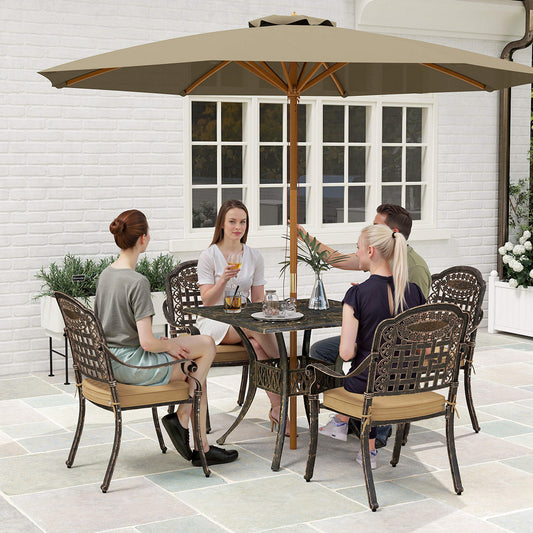 The garden dining set in use on a patio with people sitting around the table under a parasol
