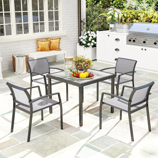 The garden dining set arranged on a patio with a bowl of fruit on the table