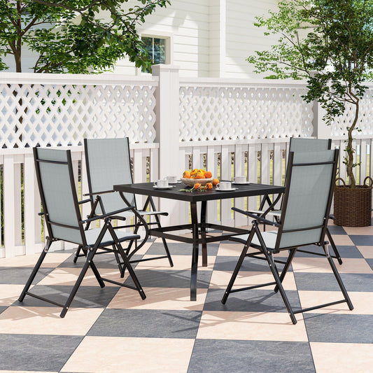 The garden dining set arranged on a patio with a white fence and greenery in the background