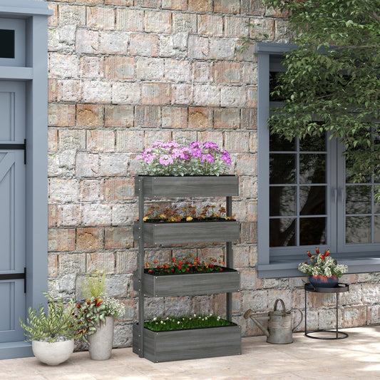 Four-tier grey wooden planter filled with flowers and plants, placed on a patio next to a brick wall and a door