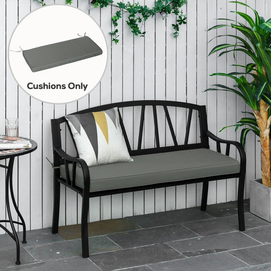 The grey garden bench cushion on a black metal bench outdoors with plants
