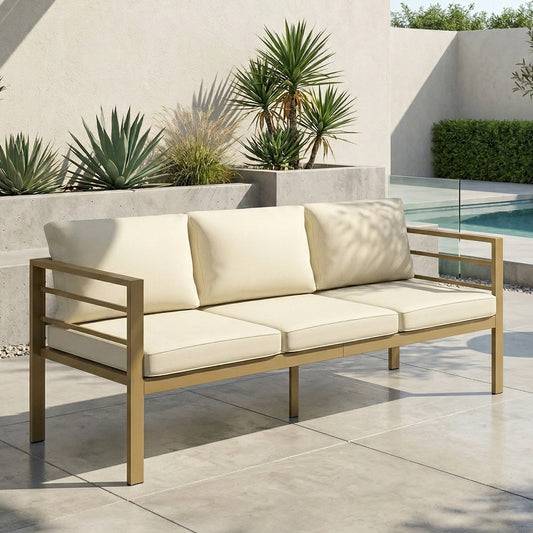 The rattan furniture sofa placed on a patio with plants in the background