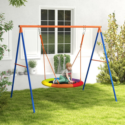 A child sits on the multicoloured nest swing seat of the kids swing set in a garden