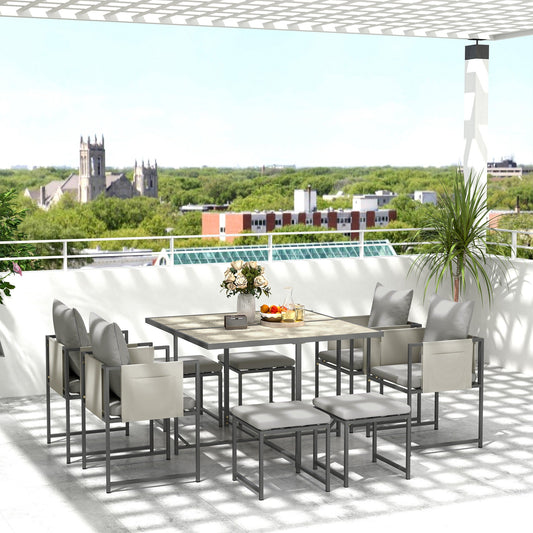 Nine-piece steel frame garden dining set arranged on a balcony with a city view