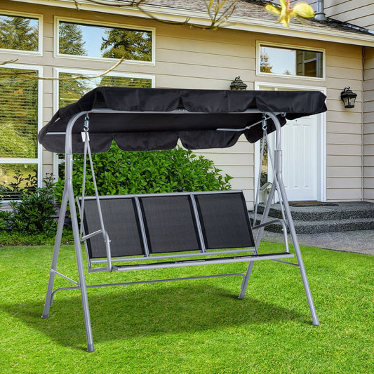 The three-seater garden swing chair in black, set up on a lawn in front of a house