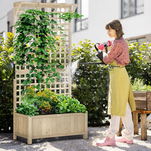 A woman waters plants in the wooden planter with trellis, showing it in use outdoors