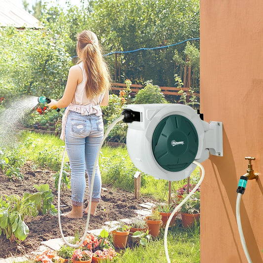A woman uses the garden hose pipe reel with lock to water plants in a sunny garden