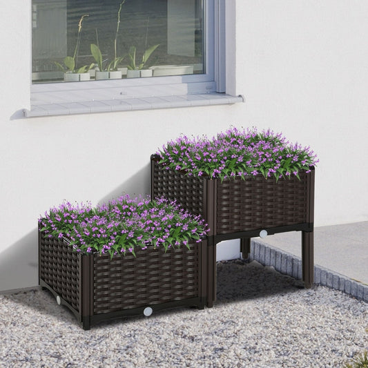 Two brown rattan effect garden raised beds filled with purple flowers on a patio