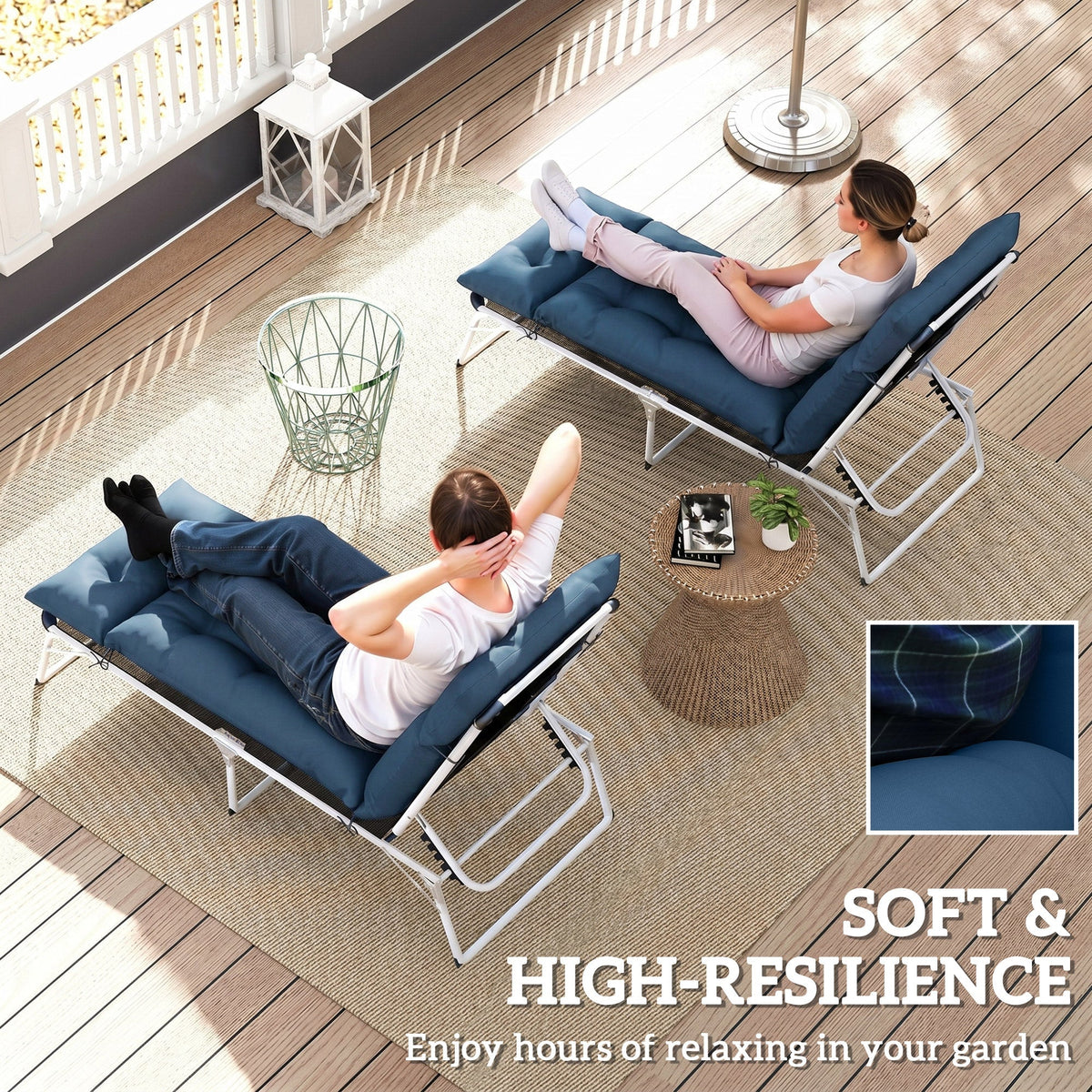 Two people relaxing on navy blue sun lounger cushions on a patio