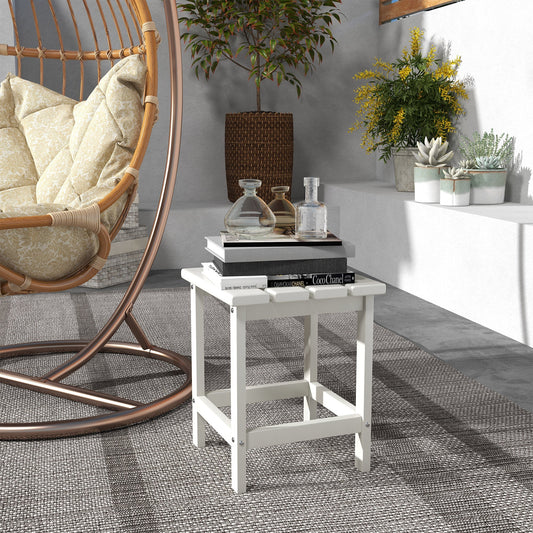 The white garden table is placed next to a hanging chair on a patio