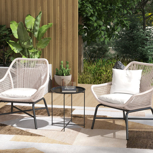 The garden table is shown in use on a patio between two chairs