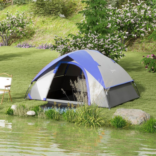 The dome tent set up on a grassy bank by a lake with a chair nearby