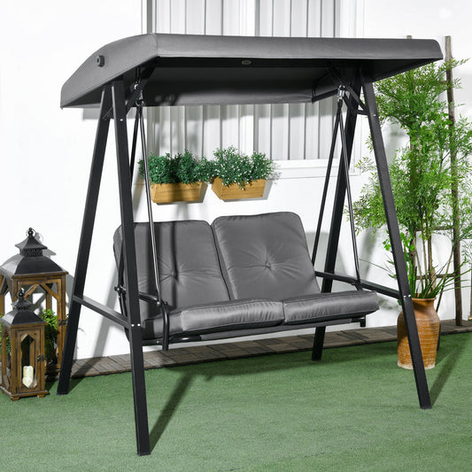 The dark grey two-seater garden swing bench sits on a patio with decorative lanterns and plants