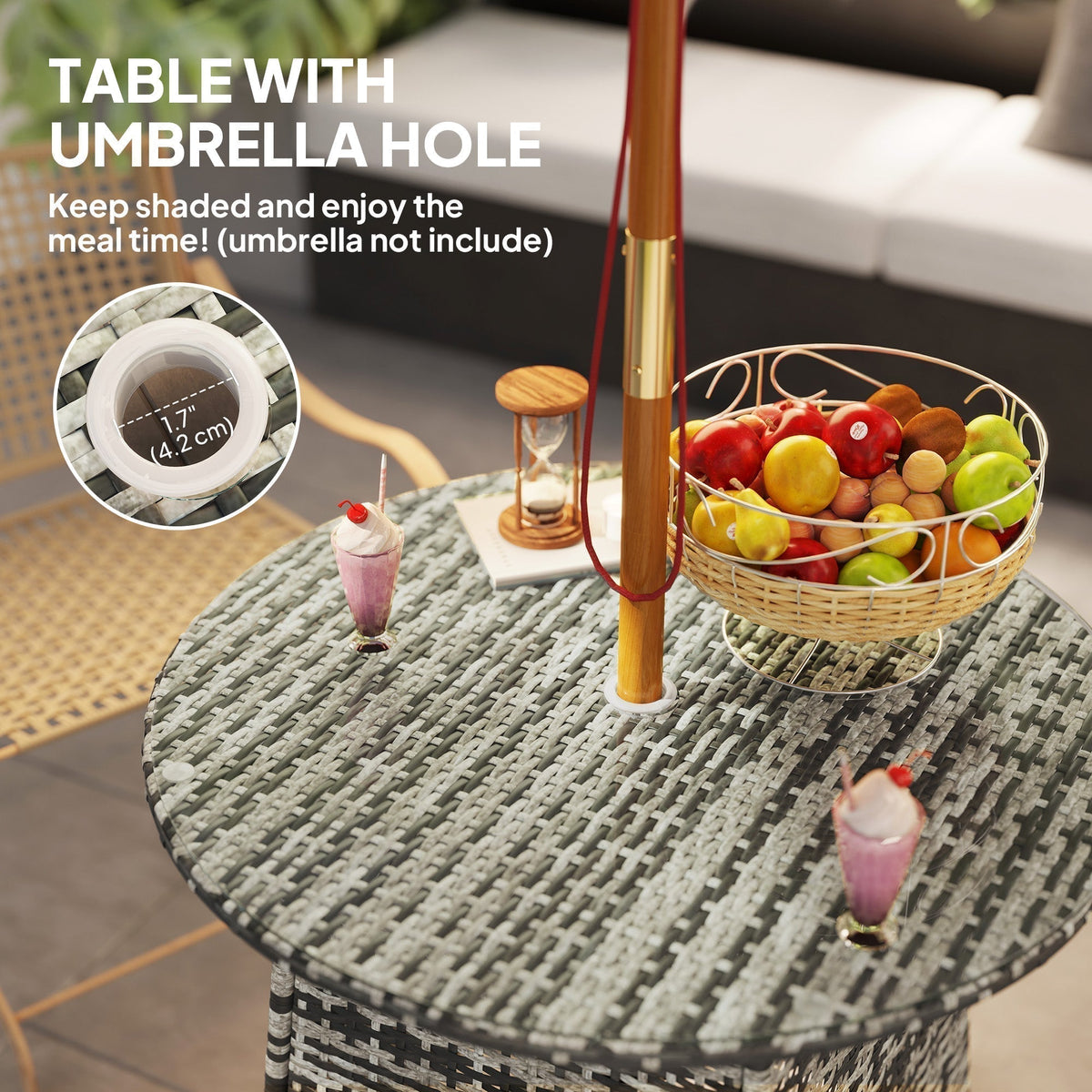 The rattan garden table has a central hole for an umbrella, with drinks and fruit on top