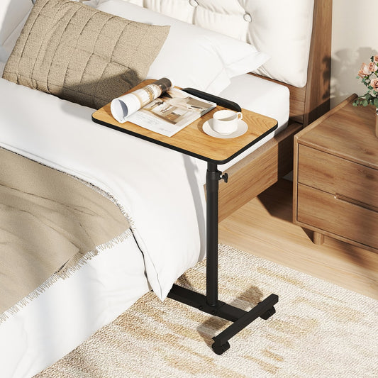 The bedside table is positioned next to a bed with a magazine and cup on it