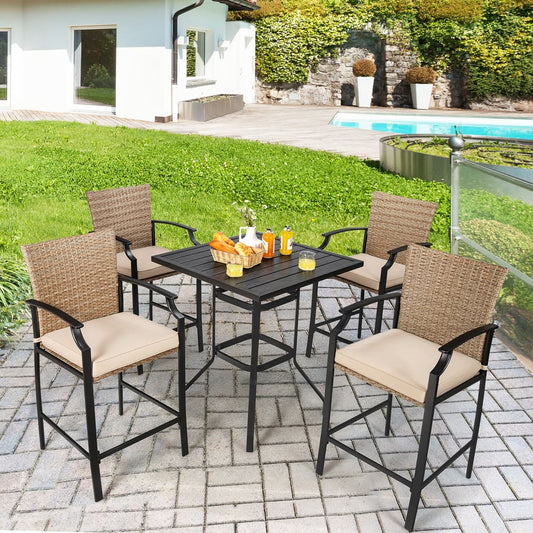 The patio furniture set arranged on a stone patio by a swimming pool with drinks and snacks