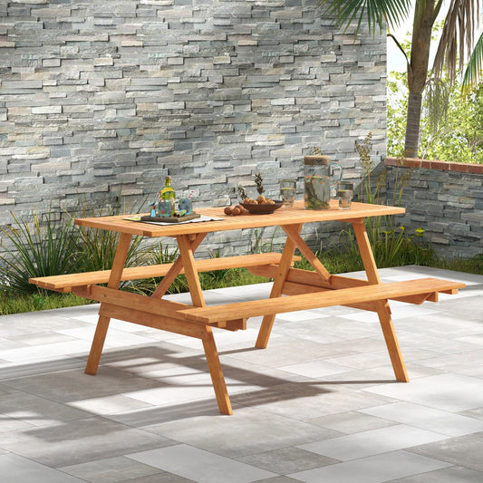 The wooden picnic table with attached benches is set up on a paved patio area