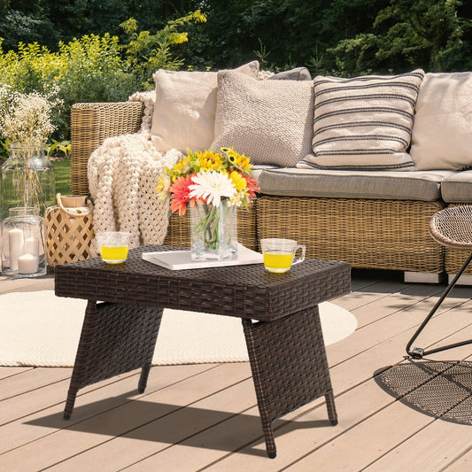 The patio coffee table placed on a wooden deck next to outdoor furniture and plants