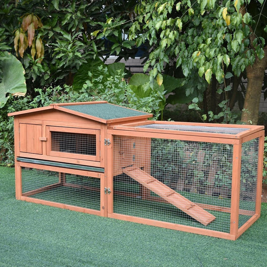 The wooden guinea pigs hutch in an outdoor garden setting on artificial grass
