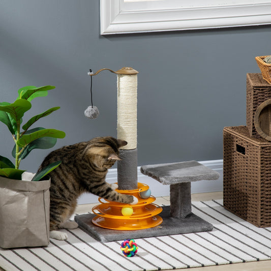 A tabby cat plays with the toy balls on the cat tree tower in a room