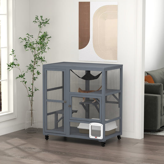 A grey wooden cat enclosure with platforms and a hammock, shown indoors with a cat inside