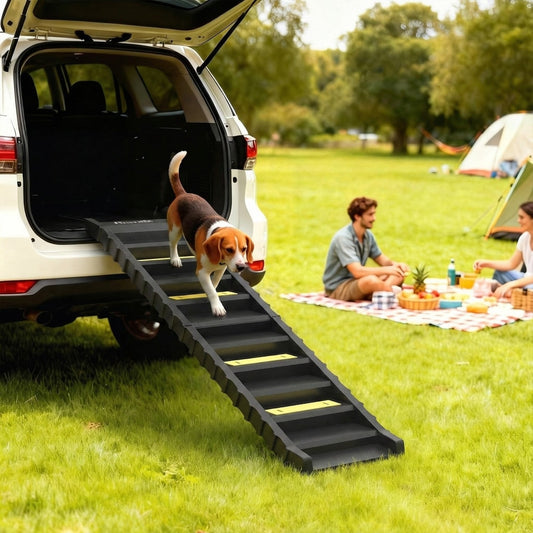 A beagle dog walks up a black pet ramp attached to the back of a car in a grassy outdoor setting