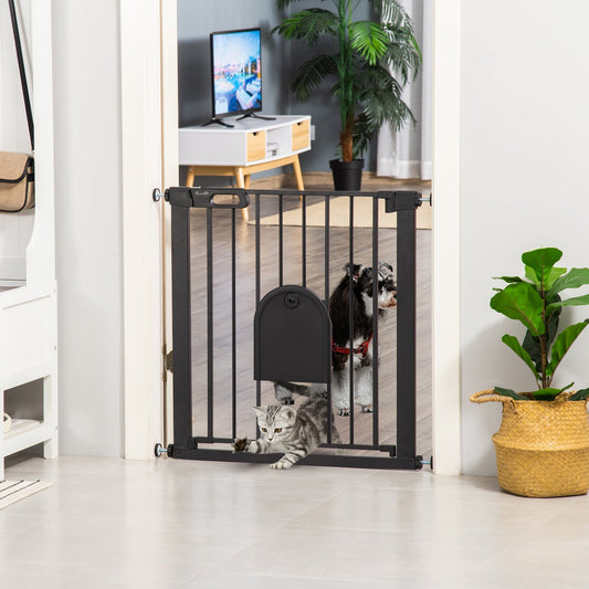 A black metal dog gate with a cat flap installed in a doorway, with a dog and cat nearby