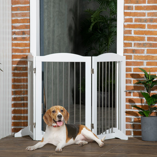 A beagle dog lying down in front of the white three-panel dog gate set up in a hallway