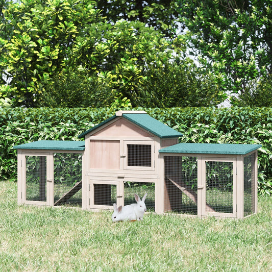 The guinea pig hutch placed on a grassy lawn with two small rabbits sitting in front