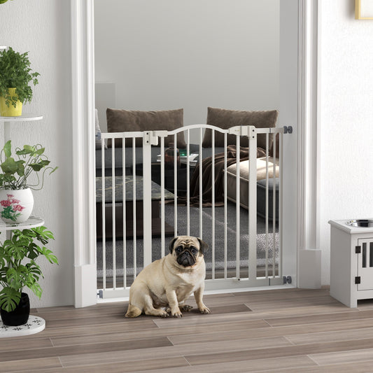 The adjustable dog gate is installed in a doorway with a pug sitting in front of it in a living room