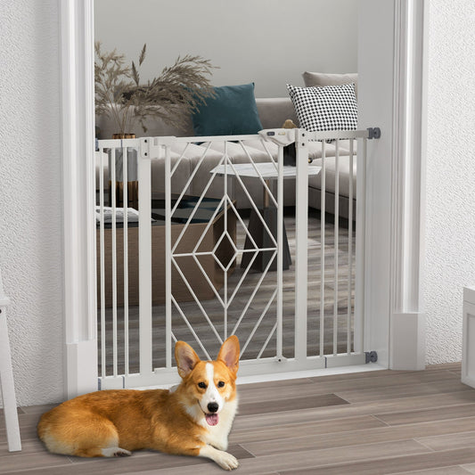 The white dog gate is installed in a doorway with a corgi lying down in front of it