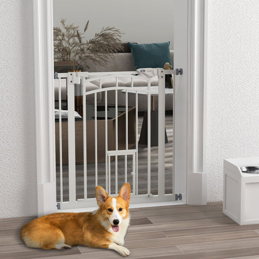 The dog gate is installed in a doorway with a corgi lying down in front of it
