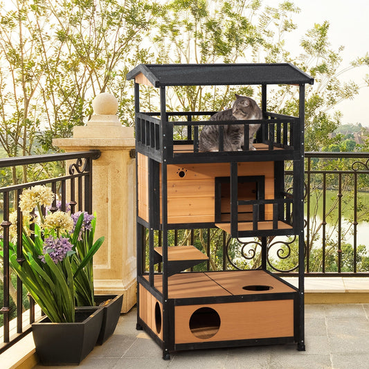 The wooden cat shelter placed on a balcony with a cat sitting on the top level