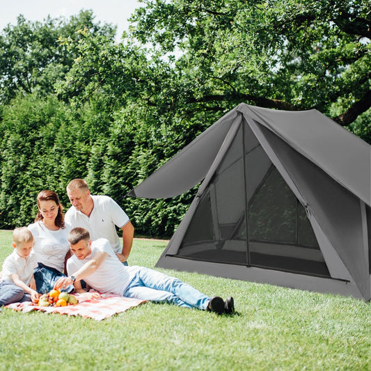 The grey camping shelter set up on a lawn with a family having a picnic nearby